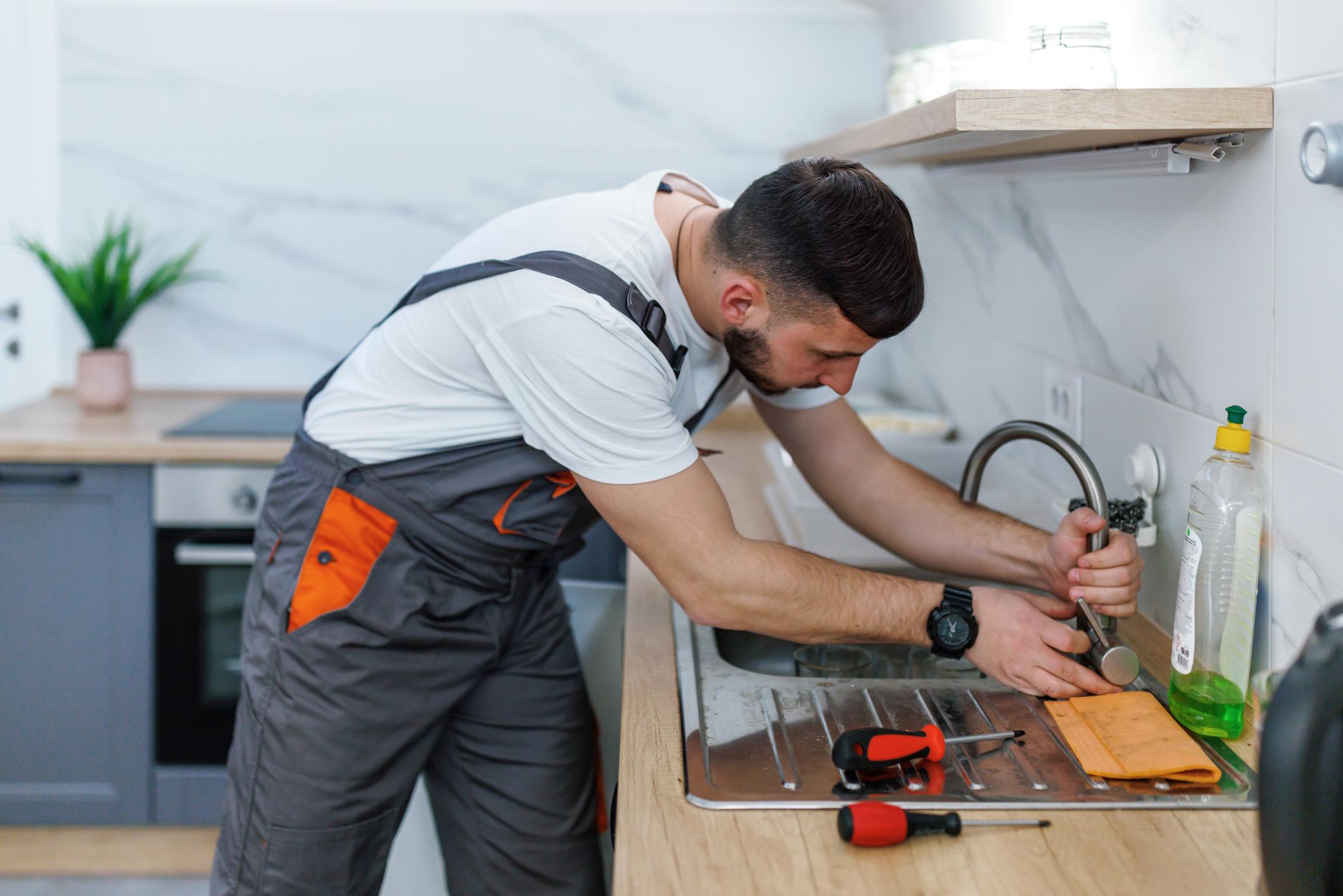 Professional plumber fixing tap in villa Northwest Murcia